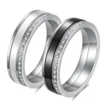 Black and white 5.5 mm ceramic spinner ring with a single row of decorative stones