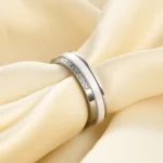 Black and white 5.5 mm ceramic spinner ring with a single row of decorative stones